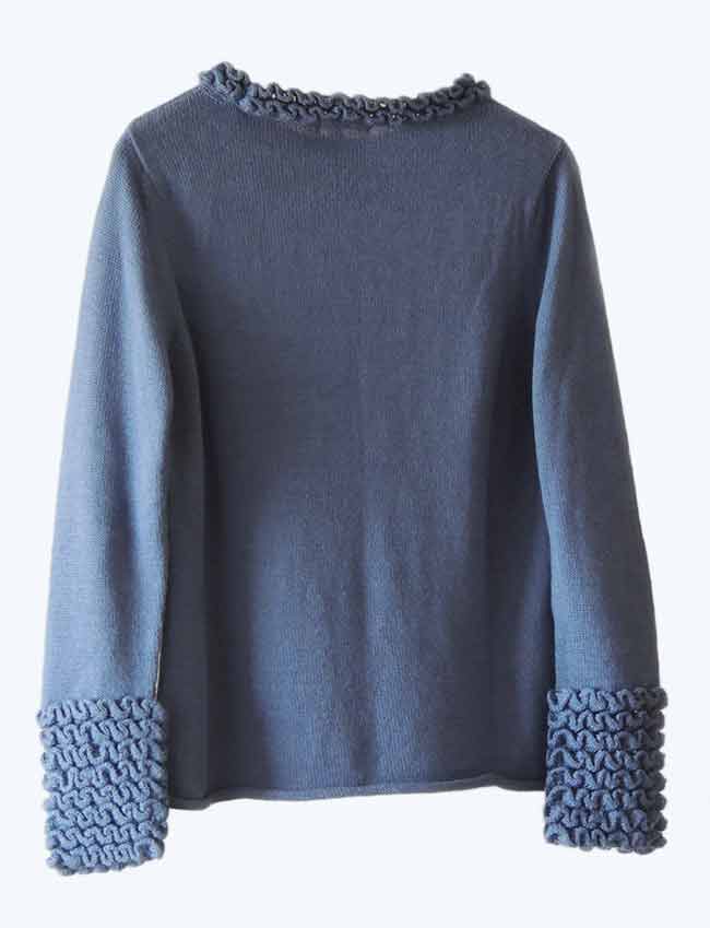 Knitted sweater blue in soft baby alpaca with a round neckline, cuffs and neck rushes pattern.